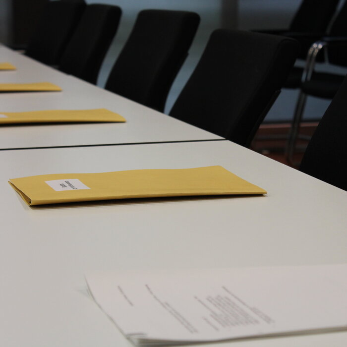 Tisch mit Mappen im Sitzungsraum