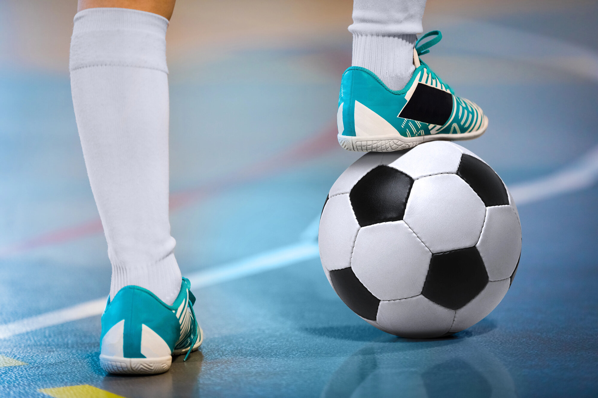 Hallenfußball, Hallenschuh tritt auf einen Fußball 